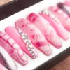 Pink version of Kylie nails with Swarovski crystals and dollars